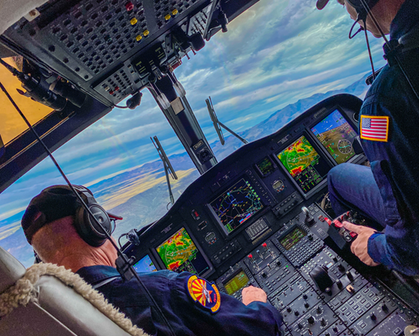 image of two pilots in a helicopter cockpit 
