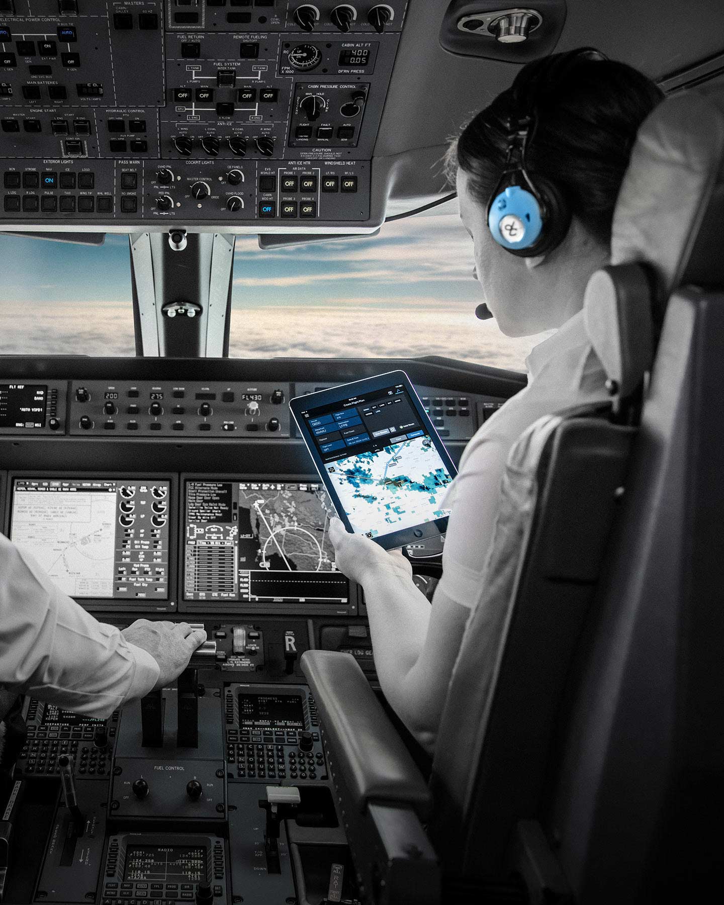 Aircraft cockpit with pilots checking avionics displays