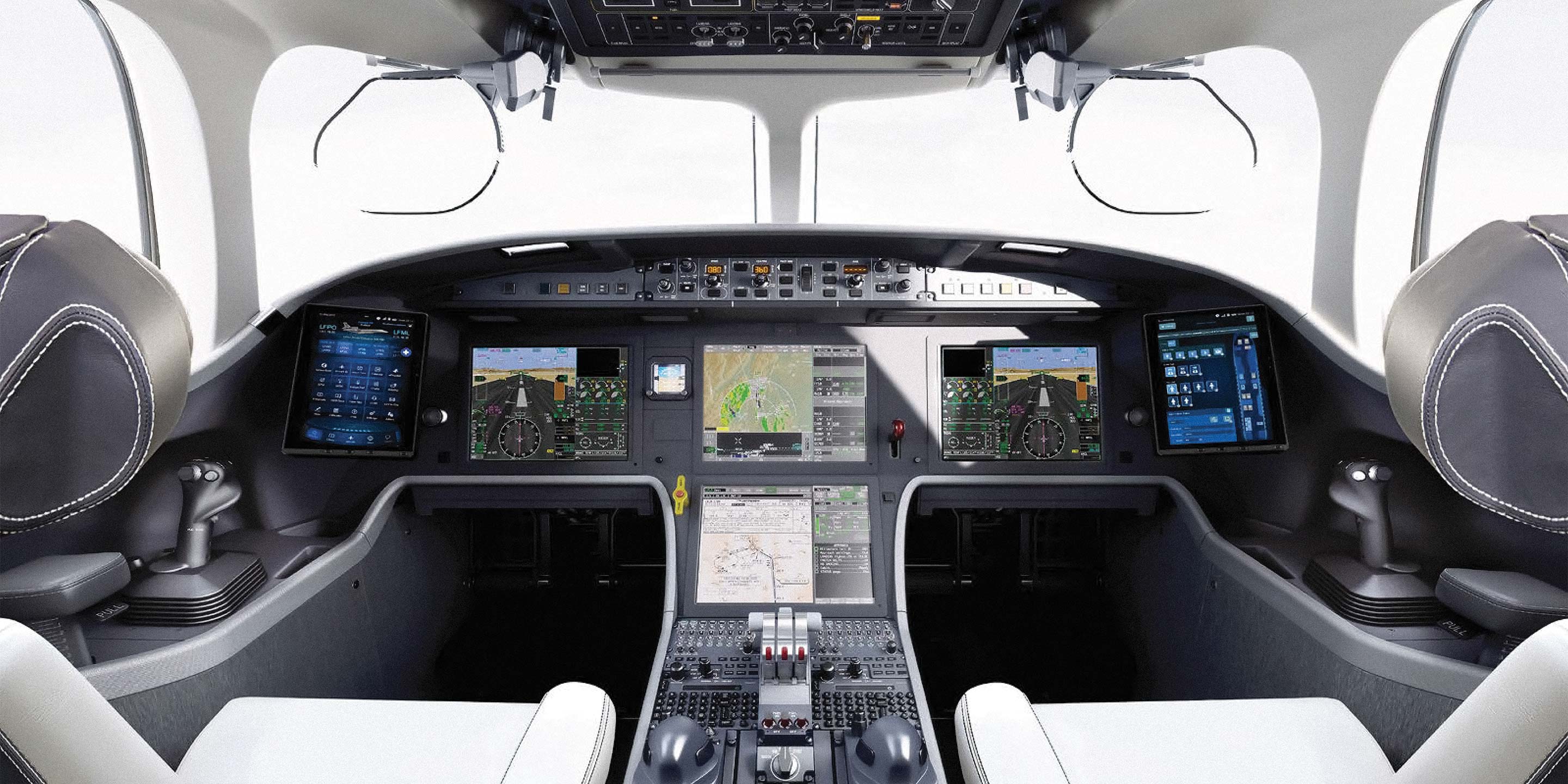 The cockpit of a private jet, with an engineer examining the controls and instruments
