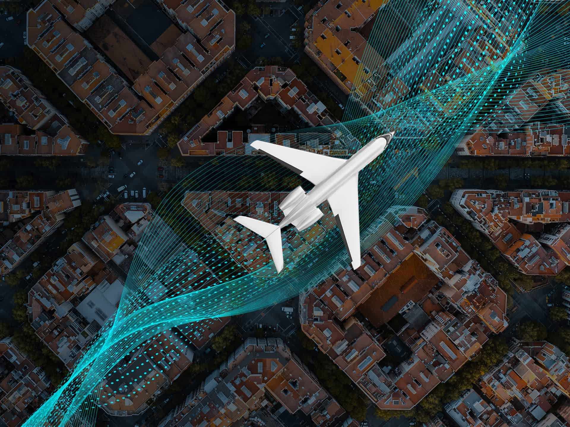 Aircraft flying over a city with buildings