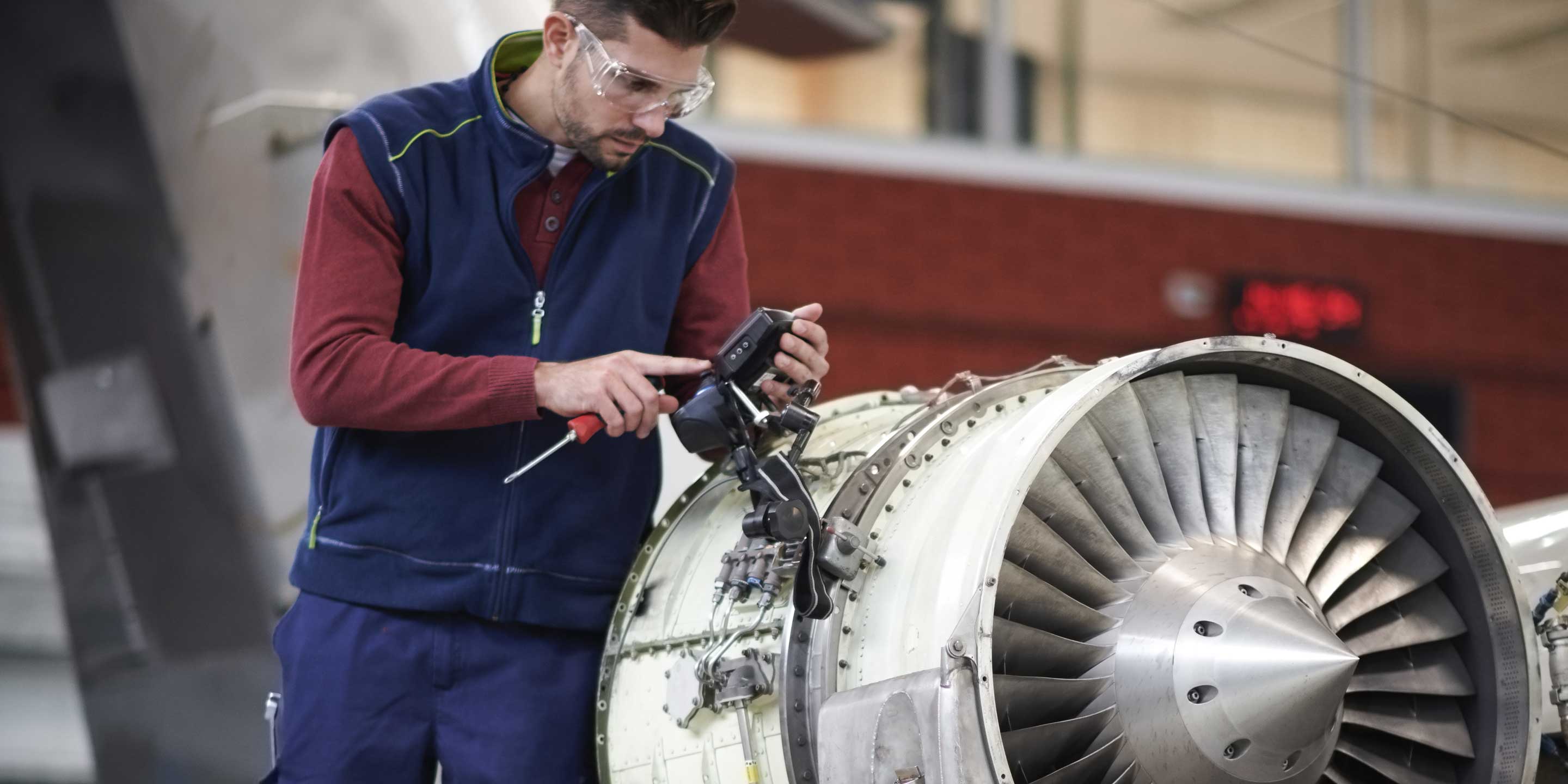 Engineer giving maintenance to an engine